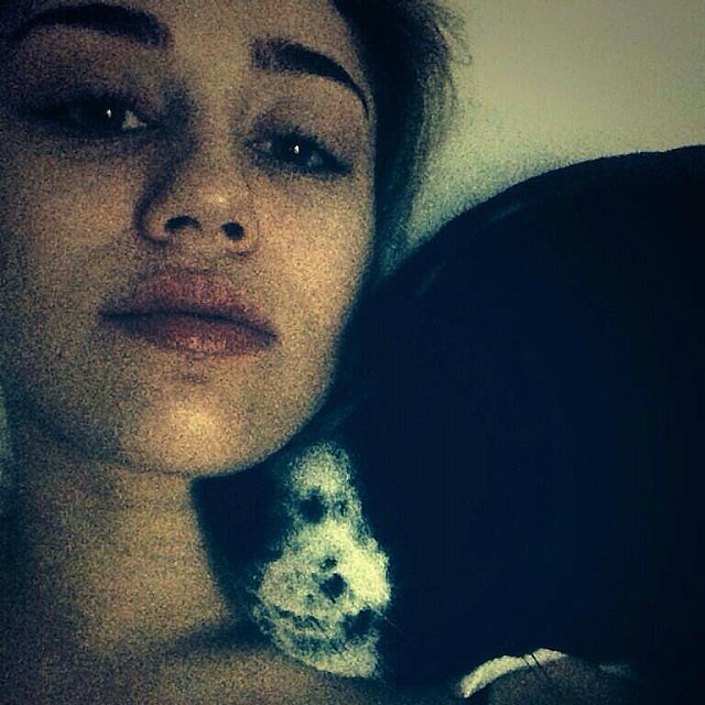 Miley-Cyrus-snuggled-up-one-her-pups