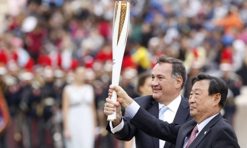 Olympic flame is handed over to South Korea Winter Games organisers during ceremony in Athens