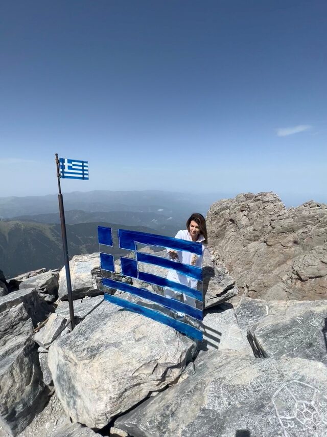 Η εικαστικός Καρολίνα Ροβύθη ζωγραφίζει την ελληνική σημαία στον Όλυμπο